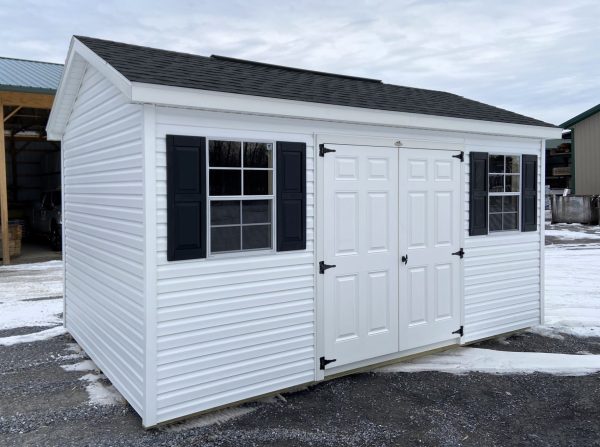 white studio shed with black trim
