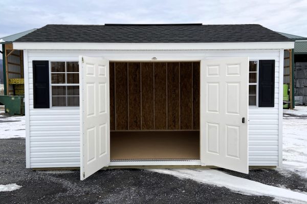 white studio shed with black trim
