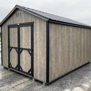 distressed brown shed with black trimming